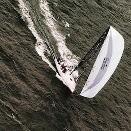 Drone shot of racing yacht under full sail 