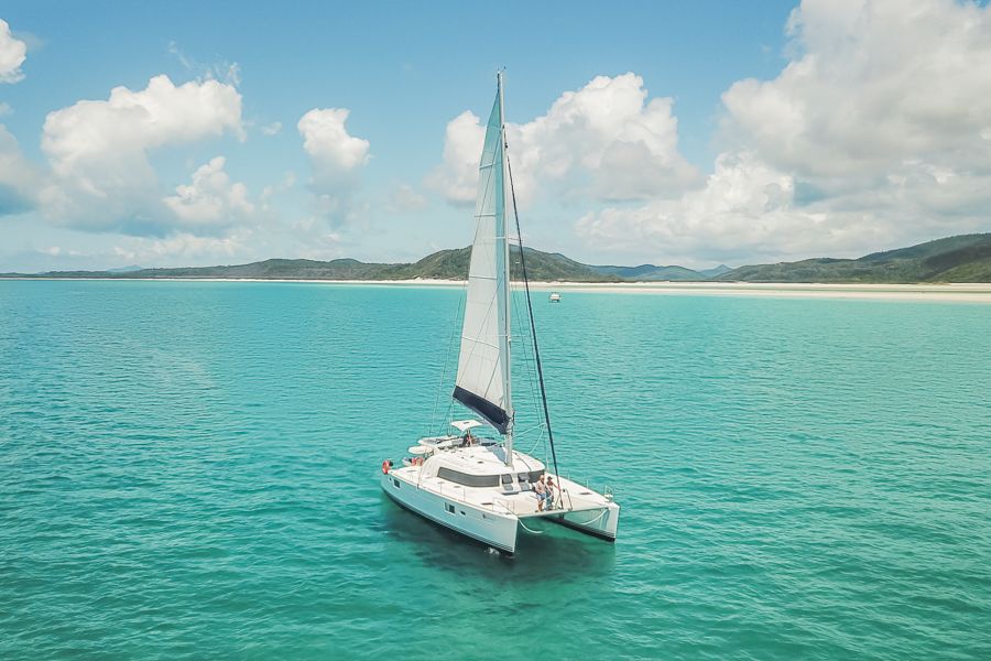 Sailing catamaran at Whitehaven Beach in the Whitsundays. 