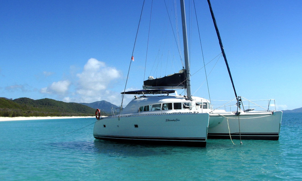 Sailing catamaran anchored at Whitehaven beach