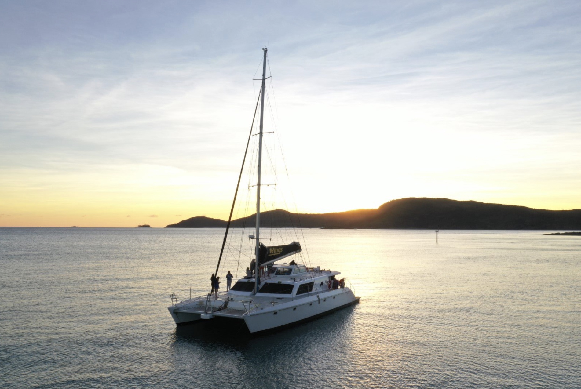 Aerial shot of sailing catamaran with spinnaker during yacht delivery with Salty. 